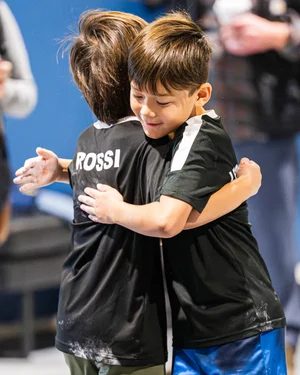 Two friends hugging at ROC City Ninja